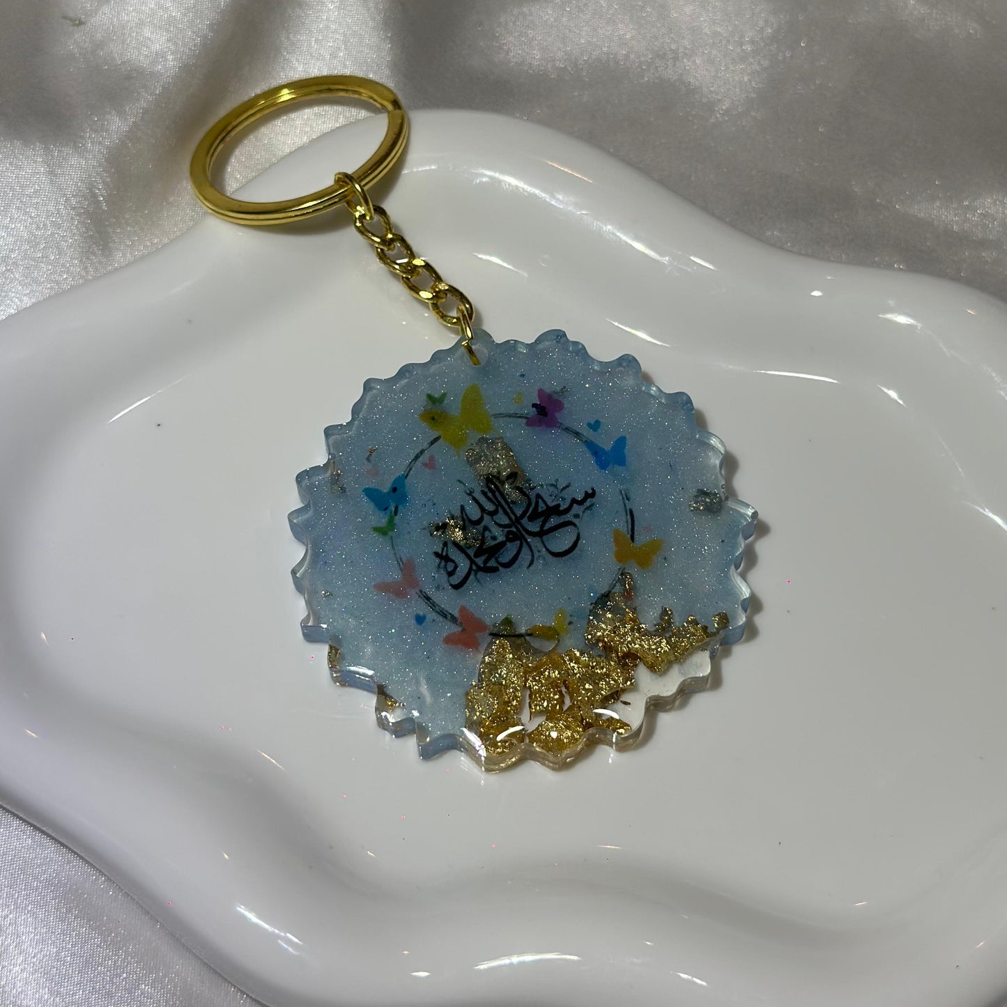 Quraan light blue with butterflies cracked keychain